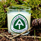 Appalachian Trail candle surrounded by forest greenery