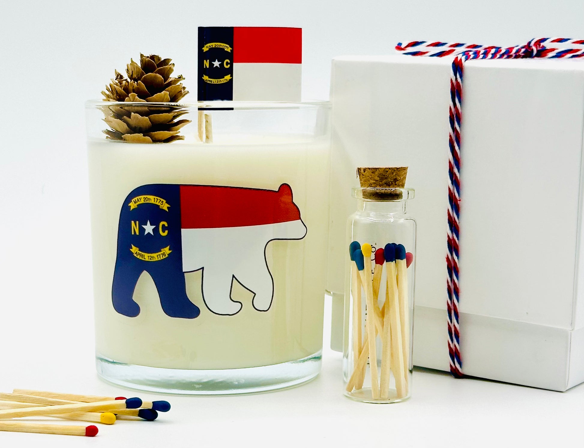 North Carolina Sweet Tea Luxury Candle | No. 1789 - The ASHEVILLE Co.™  with NC Flag Bear and Pinecone with North Carolina Flag with red, blue, yellow matches Match jar and gift box with ribbon 